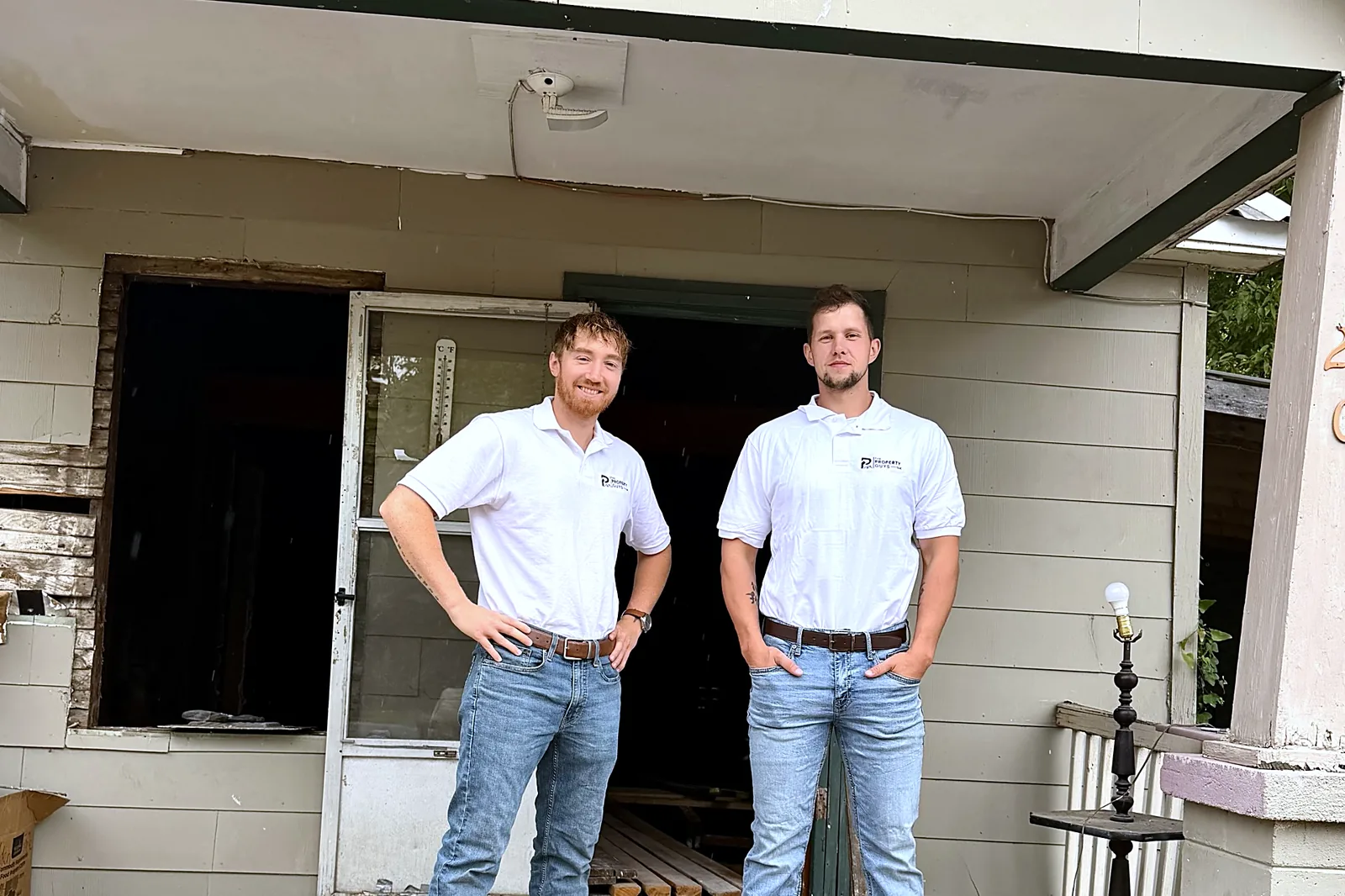 Marco and Kaleb on the porch of the house they are renovating on South 28th Street