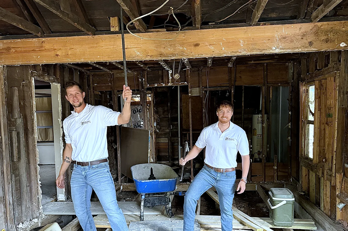 Marco and Kaleb under the exposed ceiling joists during the renovation